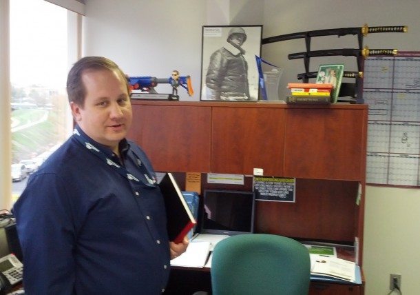 Stratacache CEO Chris Riegel in his Dayton office. Note the Gen. Patton photo and samurai swords. 