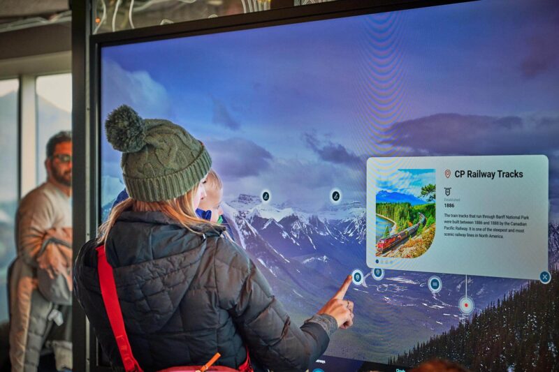 A visitor explores the Banff Gondola’s new Scout Panel, using the interactive touchscreen